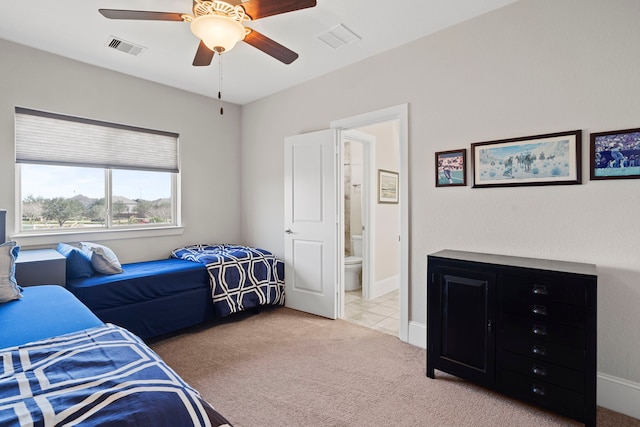 carpeted bedroom with baseboards, visible vents, and ensuite bath