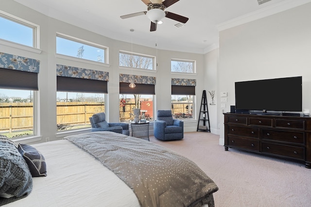 bedroom featuring visible vents, light colored carpet, a towering ceiling, ornamental molding, and baseboards