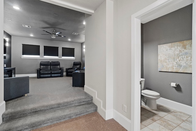 interior space featuring a textured ceiling, visible vents, and baseboards