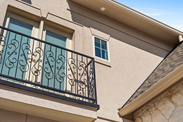 view of property exterior featuring a balcony and stucco siding