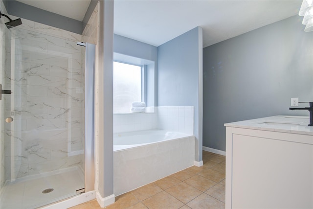 bathroom with a marble finish shower, baseboards, tile patterned flooring, vanity, and a bath