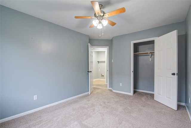 unfurnished bedroom featuring a closet, light colored carpet, ceiling fan, and baseboards