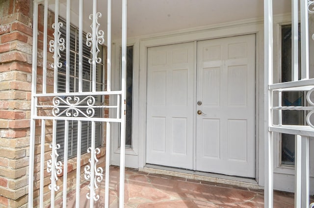 view of exterior entry with brick siding