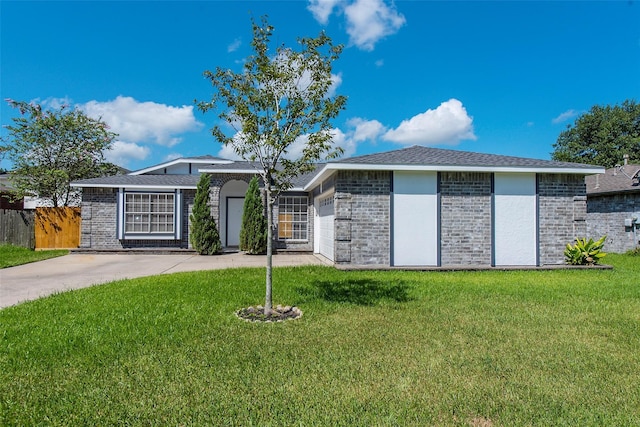 view of front of house with concrete driveway, brick siding, and a front yard