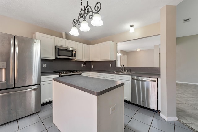 28907 Sedgefield St, Spring, TX 77386 - kitchen with stainless steel appliances, a sink, dark countertops, and light tile patterned floors