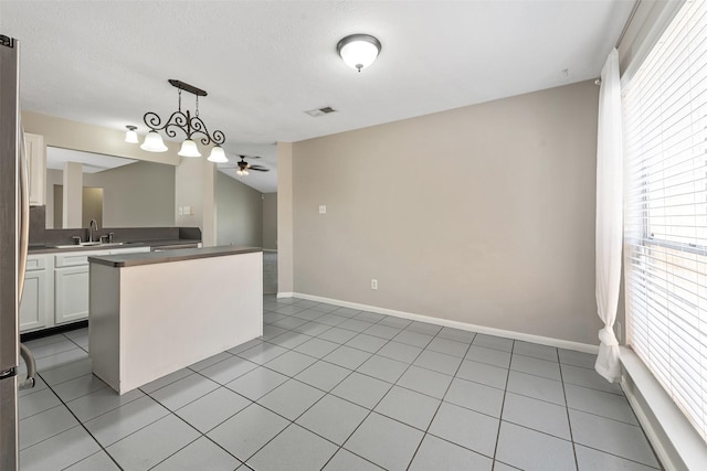 28907 Sedgefield St, Spring, TX 77386 - kitchen featuring a ceiling fan, white cabinetry, baseboards, decorative light fixtures, and a sink