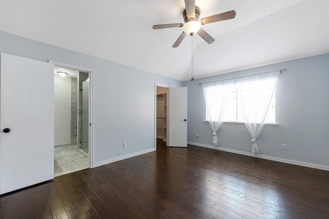 28907 Sedgefield St, Spring, TX 77386 - unfurnished bedroom featuring lofted ceiling, wood finished floors, a walk in closet, ensuite bath, and baseboards