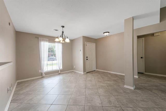 28907 Sedgefield St, Spring, TX 77386 - spare room featuring a chandelier, light tile patterned floors, and baseboards