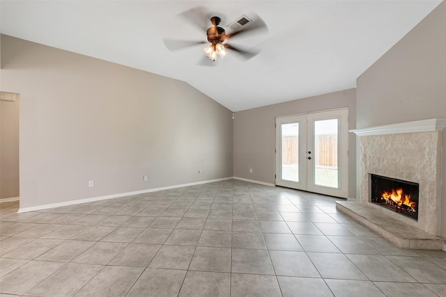 28907 Sedgefield St, Spring, TX 77386 - unfurnished living room with lofted ceiling, light tile patterned flooring, ceiling fan, a premium fireplace, and french doors