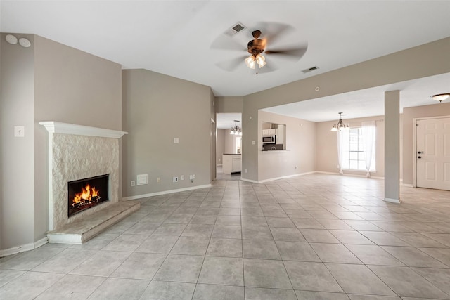 28907 Sedgefield St, Spring, TX 77386 - unfurnished living room with a fireplace, ceiling fan, light tile patterned floors, a chandelier, and baseboards