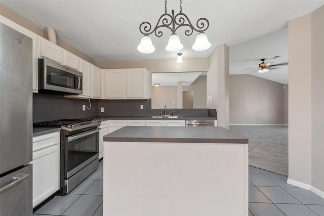28907 Sedgefield St, Spring, TX 77386 - kitchen featuring appliances with stainless steel finishes, a sink, dark countertops, light tile patterned flooring, and white cabinetry