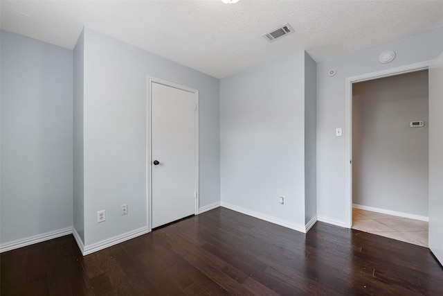 28907 Sedgefield St, Spring, TX 77386 - empty room with wood finished floors, baseboards, a smoke detector, and a textured ceiling