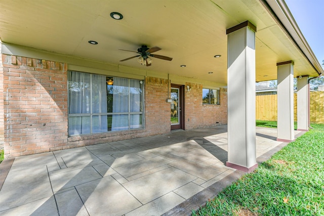 view of patio featuring ceiling fan and fence