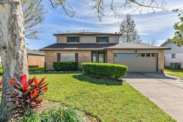 traditional-style house with an attached garage, cooling unit, brick siding, concrete driveway, and a front yard