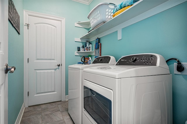 laundry room featuring laundry area, separate washer and dryer, and baseboards