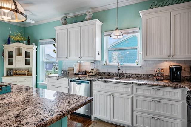 kitchen with stainless steel dishwasher, a sink, white cabinetry, and pendant lighting