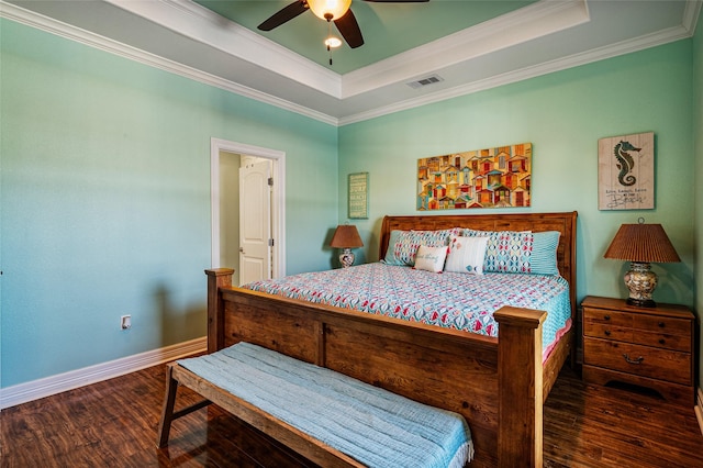 bedroom featuring crown molding, visible vents, a raised ceiling, and dark wood-style flooring