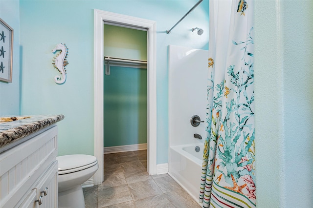 full bathroom featuring a walk in closet, toilet, shower / tub combo, vanity, and baseboards