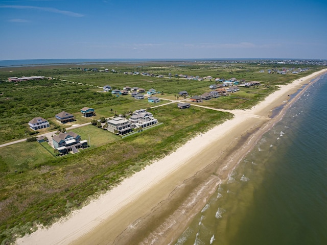 bird's eye view featuring a water view and a beach view