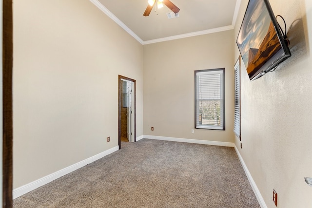 unfurnished room featuring baseboards, ornamental molding, and carpet flooring