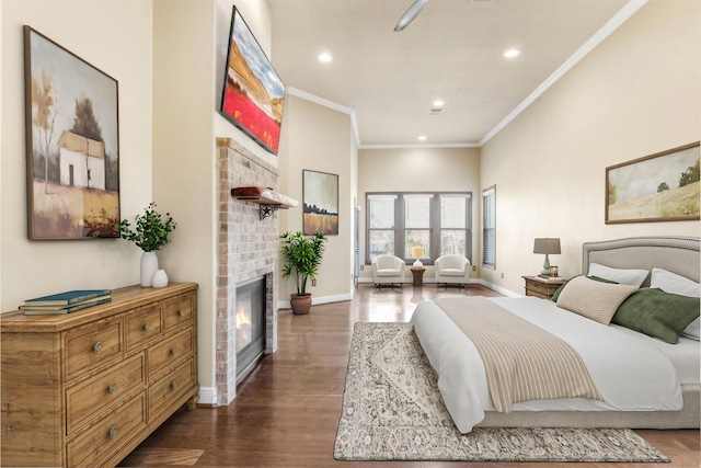 bedroom with dark wood-style floors, crown molding, a fireplace, recessed lighting, and baseboards