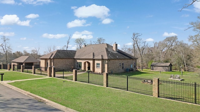 view of front of house featuring a fenced front yard, brick siding, and a front lawn