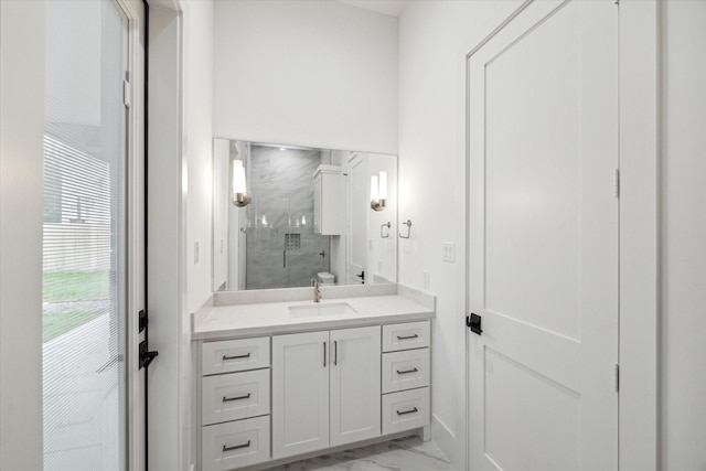 full bath featuring marble finish floor, vanity, and a stall shower