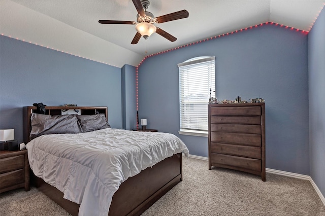 bedroom featuring carpet flooring, vaulted ceiling, baseboards, and ceiling fan