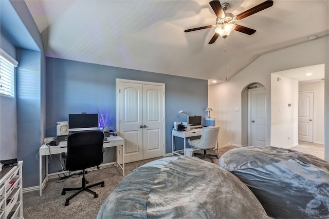 bedroom featuring vaulted ceiling, carpet, arched walkways, and baseboards