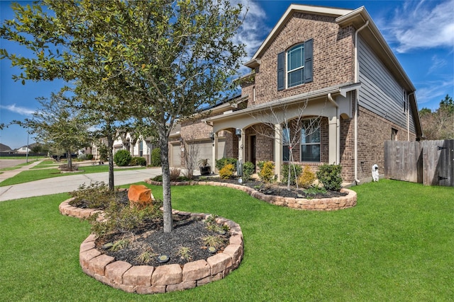 traditional-style home with a front yard, brick siding, driveway, and fence