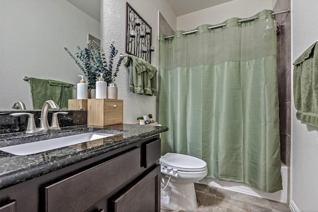 full bathroom featuring toilet, a textured wall, shower / bathtub combination with curtain, and vanity