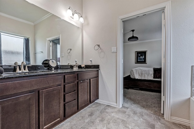 full bathroom with ornamental molding, a sink, and double vanity