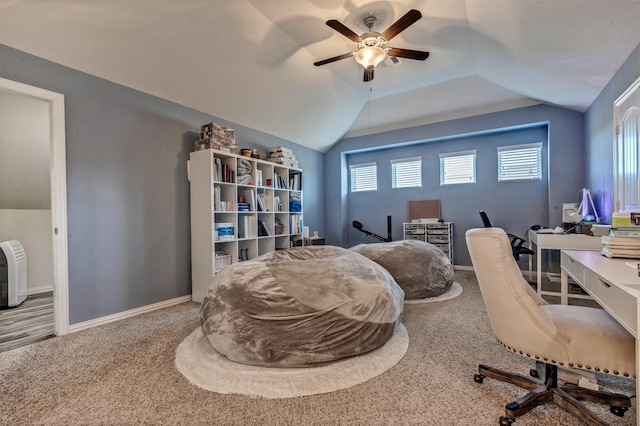 home office featuring lofted ceiling, carpet, a ceiling fan, and baseboards