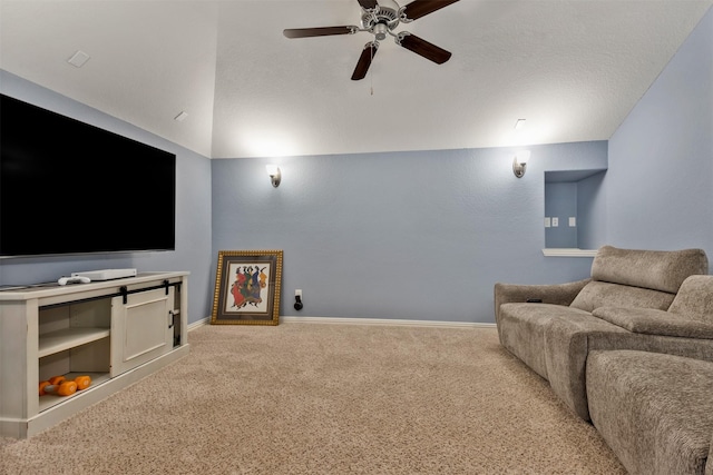 cinema with vaulted ceiling, carpet flooring, a ceiling fan, and baseboards