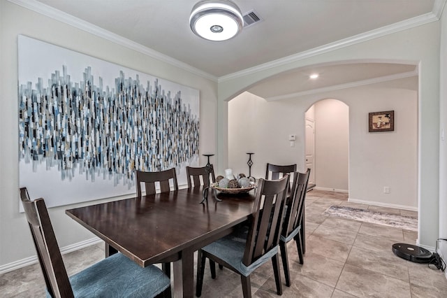 dining room featuring arched walkways, light tile patterned flooring, visible vents, baseboards, and ornamental molding