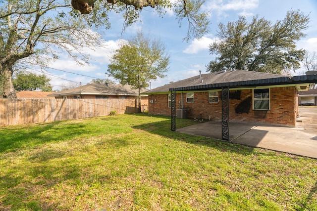 view of yard featuring a patio area, fence, and central air condition unit