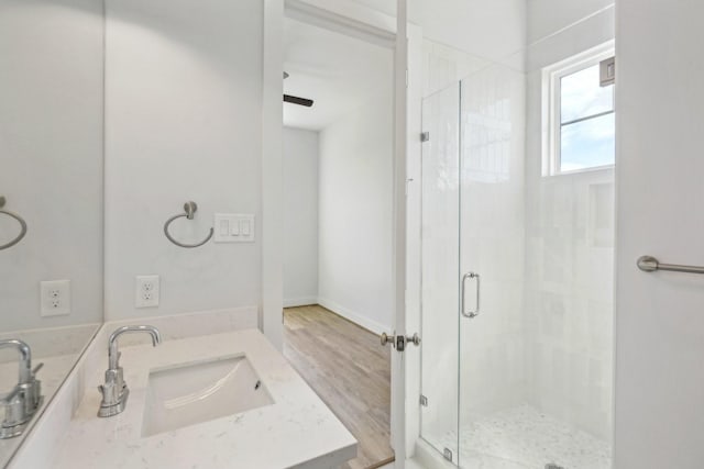 26726 Estuary Dr, Galveston, TX 77554 - bathroom with baseboards, vanity, a shower stall, and wood finished floors