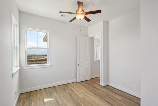 26726 Estuary Dr, Galveston, TX 77554 - unfurnished bedroom featuring baseboards, visible vents, ceiling fan, and light wood finished floors