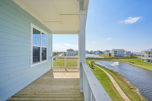 26726 Estuary Dr, Galveston, TX 77554 - wooden terrace featuring a water view and a lawn