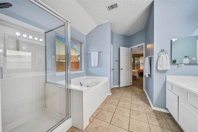 bathroom featuring visible vents, ensuite bathroom, a textured ceiling, vanity, and tile patterned flooring