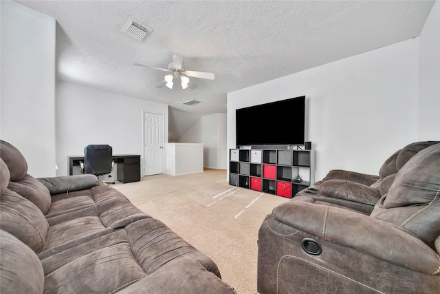 living room with a textured ceiling, a ceiling fan, visible vents, and light colored carpet