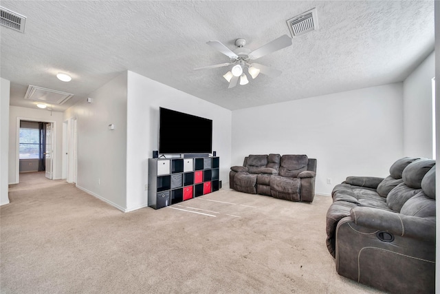 living room featuring light carpet, attic access, visible vents, and ceiling fan