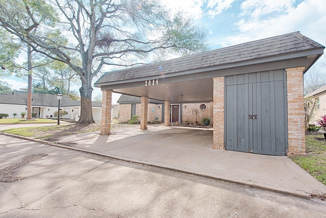 exterior space featuring a carport and concrete driveway