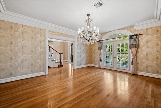 unfurnished dining area with stairway, wood finished floors, visible vents, and crown molding