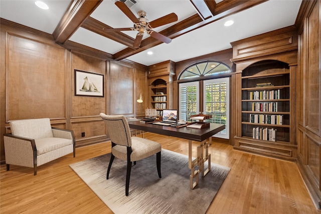 office space with ceiling fan, light wood-style flooring, a decorative wall, coffered ceiling, and beamed ceiling