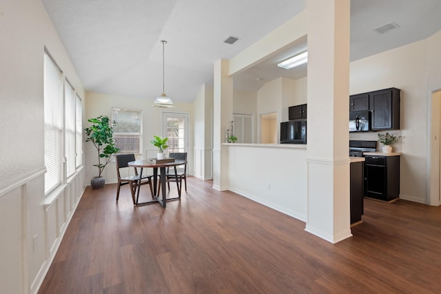 dining room with baseboards, vaulted ceiling, visible vents, and dark wood finished floors