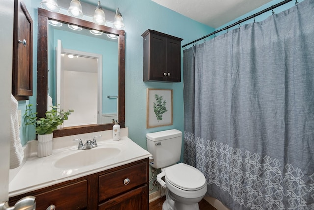 full bathroom with toilet and vanity