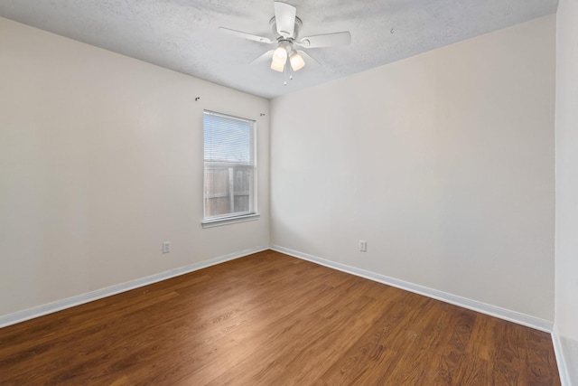 spare room featuring ceiling fan, a textured ceiling, baseboards, and wood finished floors