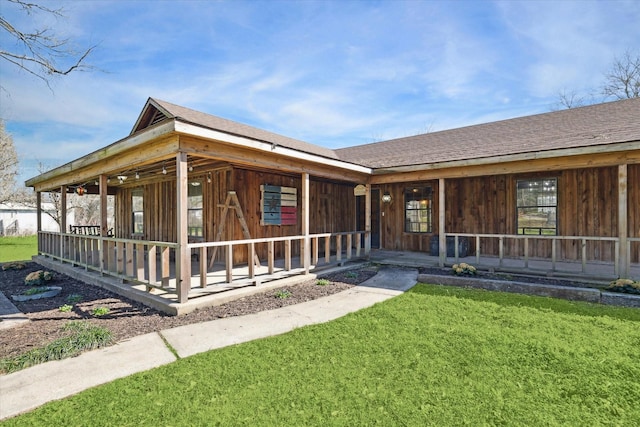 view of front facade with covered porch and roof with shingles