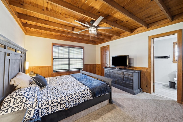 bedroom with a wainscoted wall, beamed ceiling, and wood ceiling